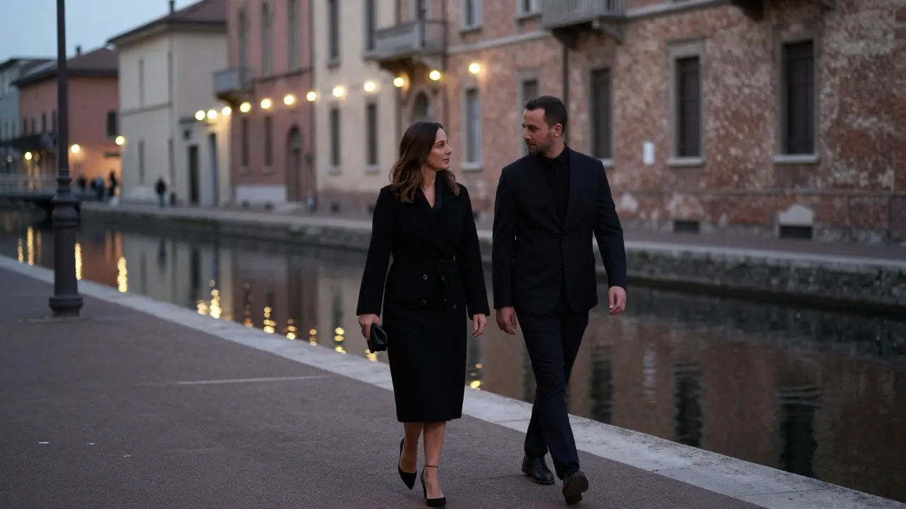 A couple walking peacefully along the Navigli canal at night, immersed in quiet conversation.