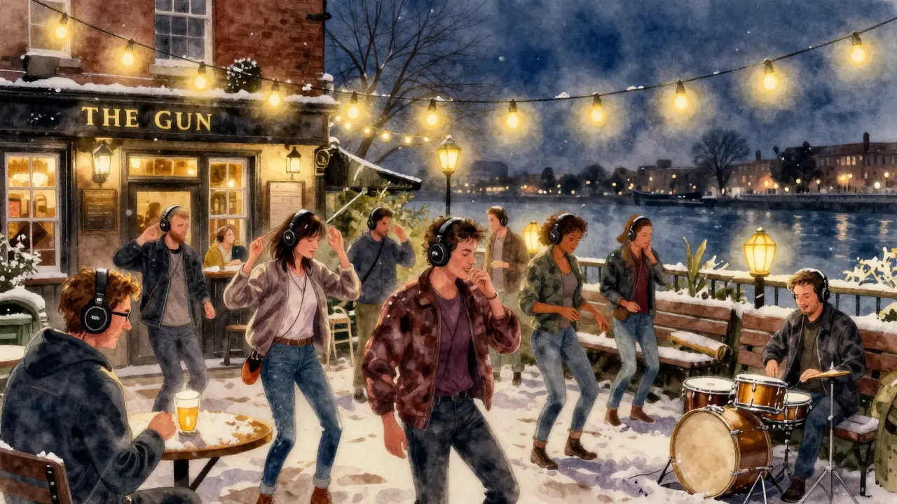 A silent disco in a snowy pub garden with people dancing in headphones under string lights.